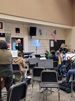 Orchestra Director Jay Gillespie leads students in final rehearsals for the spring musical, Beauty and the Beast.