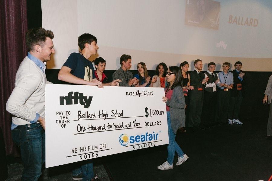 Photo courtesy of Michelle Ann HenleyJuniors Leo Pfeifer and Meagen Tajalle accept a check for $1500 after winning NFFTY’s 48 Hour Film Off competition. The money will go towards the Digital Filmmaking Program.