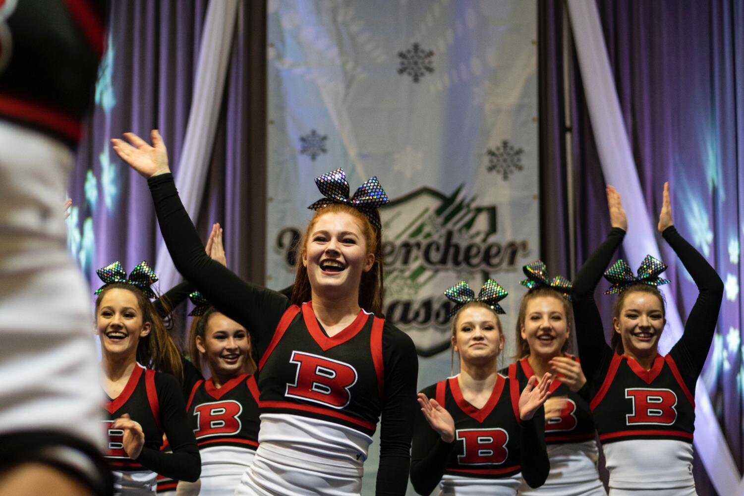 Senior Avery Miller waves to the crowd at the Winter Cheer Classic earlier this year. Miller plans on being a base for SDSU cheer team this fall.