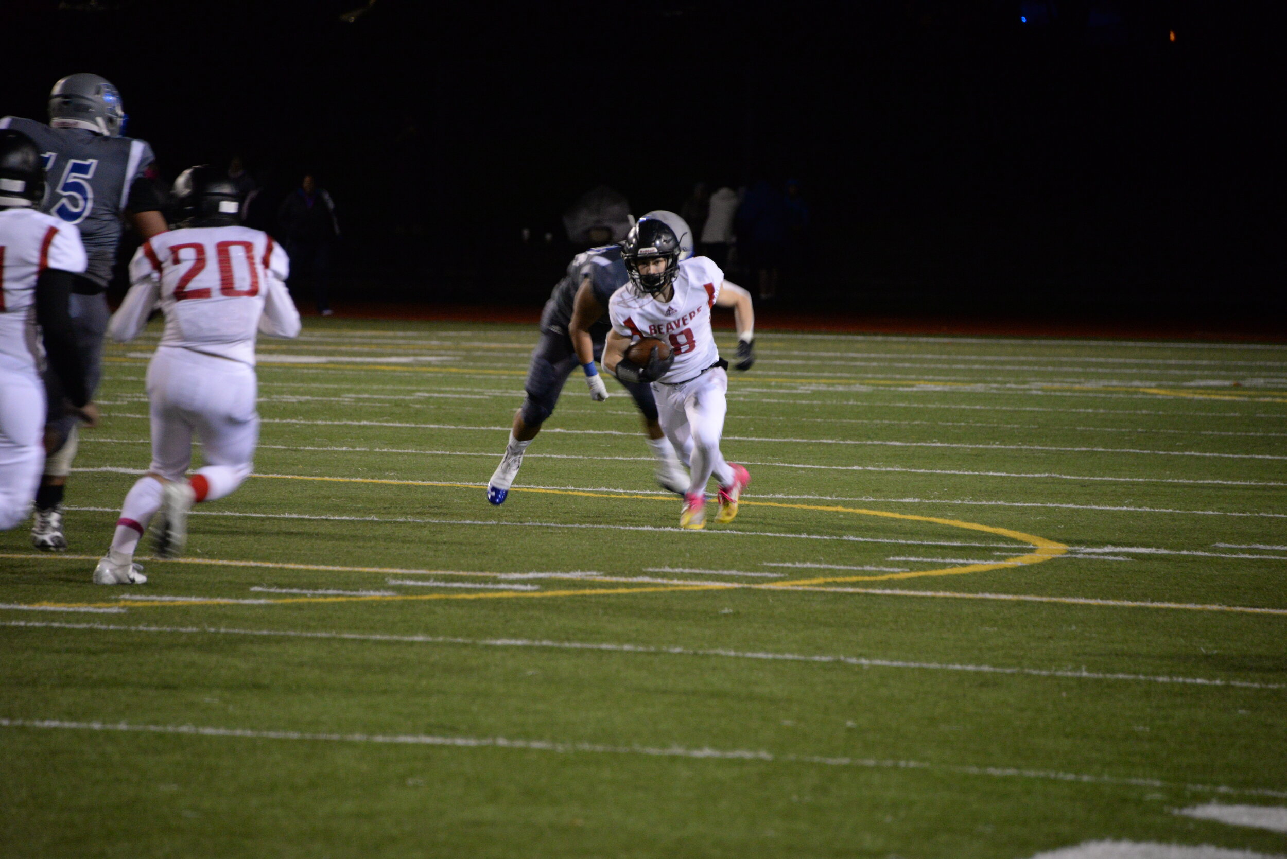 In the game against Ingraham on Oct. 18, senior George Blue, who scored three of the touchdowns, runs past the Ingraham opponents. Beavers won 29-13 (Ian Anderson)