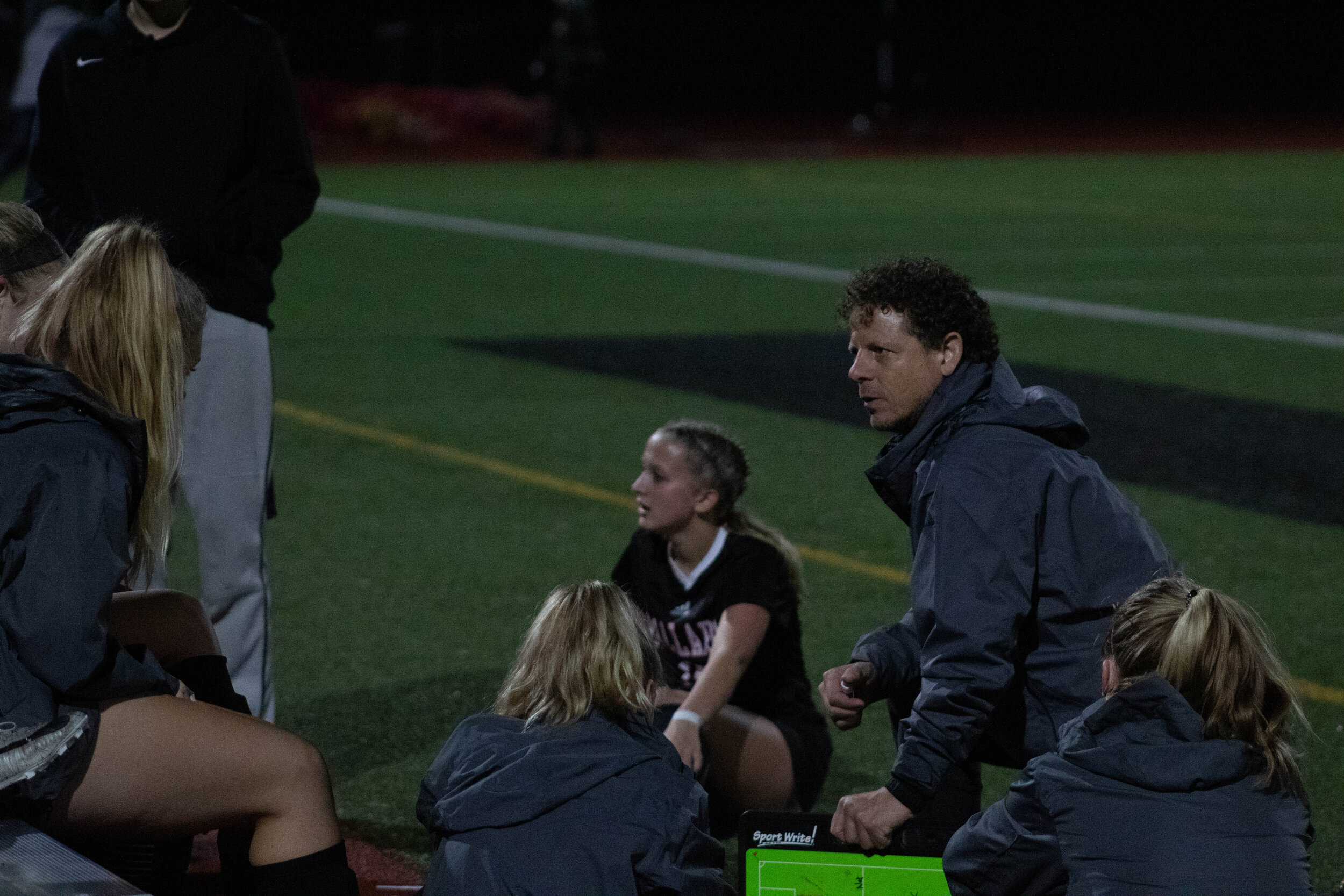 Head coach Sam Macca talks with the team during halftime against West Seattle on Oct. 22. “I want to create a legacy of girls wanting to be a part of this program,” Macca said. (0-5) (Skye McDonald)