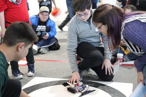 Katie Read KearneySophomore Wyatt Gowen prepares his robot to compete on Claiborne Field. Approximately 3,000 people were in attendance at the Special Olympics Unified Robotics Championship.