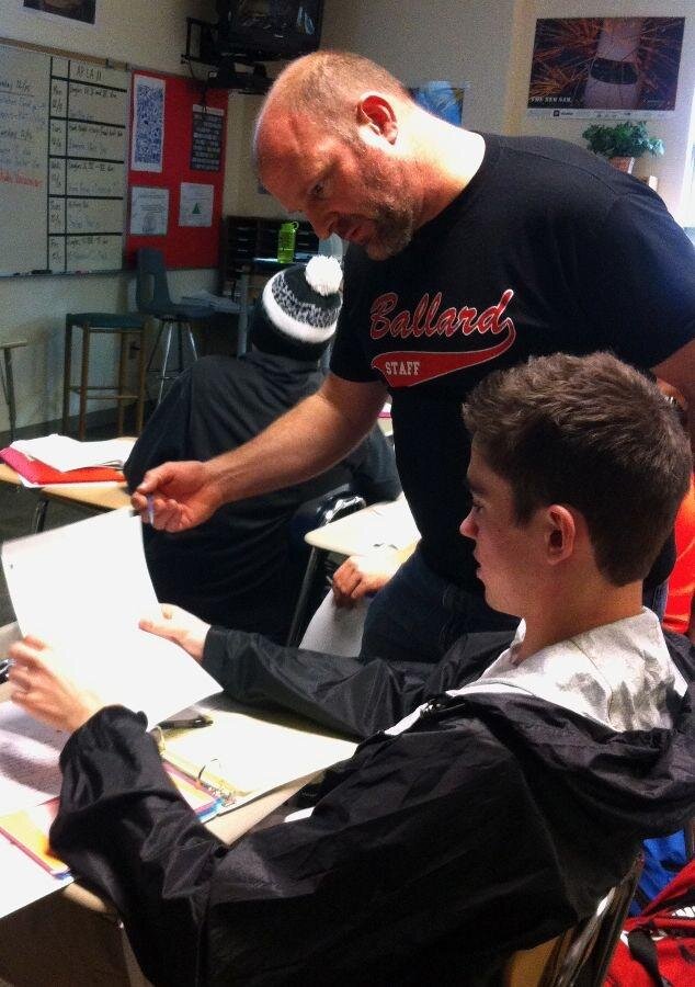 Ceci AtkinsLanguage Arts teacher Brian Reardon helps a student with his classwork.