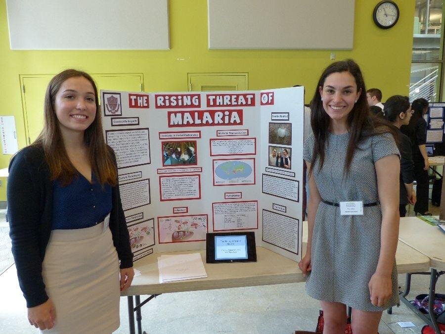 Penny PagelsSeniors Paloma Roberts-Buceta and Tiara Adler show off their Bio Expo project, "The Rising Threat of Malaria."