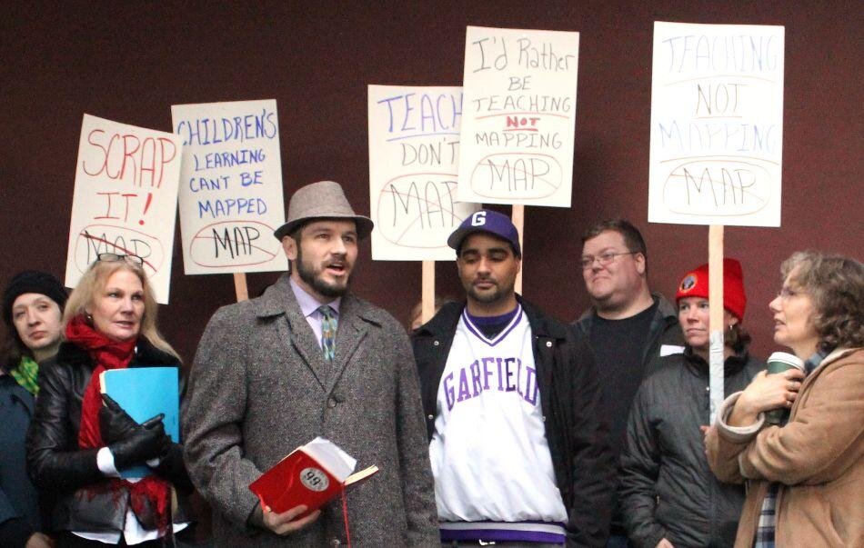 Anna Ferkingstad(Above) Science teacher Noam Gundle stands next to Garfield’s Jesse Hagopian as he gives a speech at a rally for the boycott at the John Stanford Center for Educational Excellence on January 23. (Right) Students, teachers, and parent…