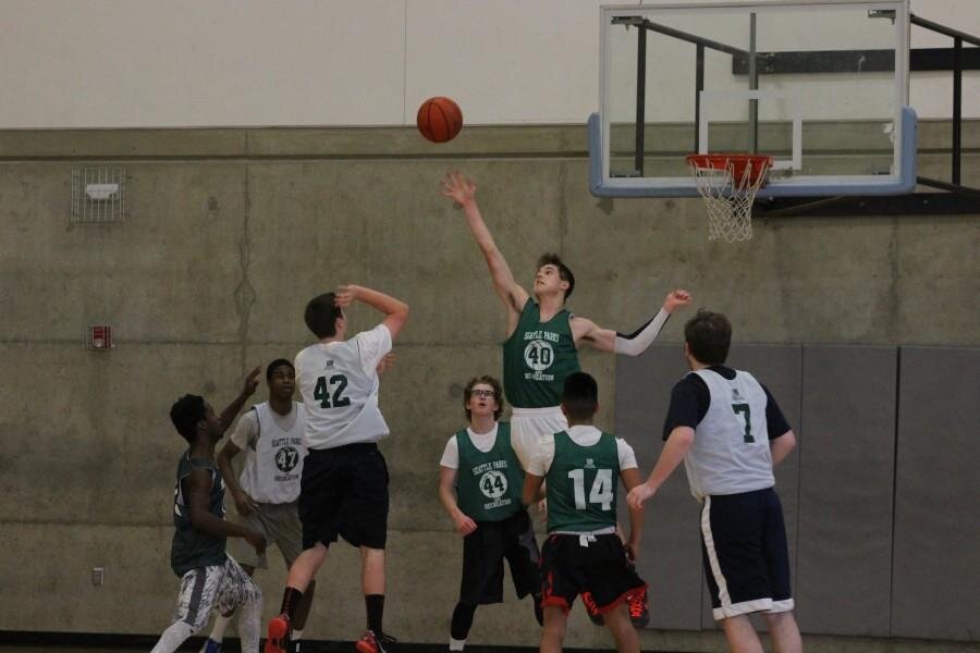 Sam HeikellJunior Sam Blank reaches to block the opposing player's shot. Blank helped lead his team to a 15 point victory against West Seattle.