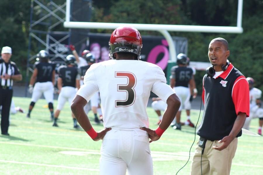 Ruby StaufferJoey Thomas instructs quarterback Davine Tullis on the sideline of their week three matchup against West Salem. Ballard (8-3) finished with their best record in the last ten years.