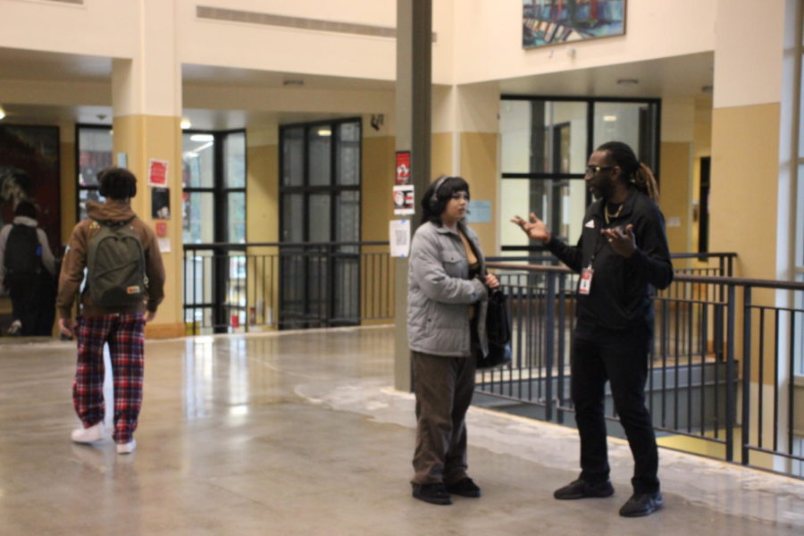 Dwayne greets students in the halls.