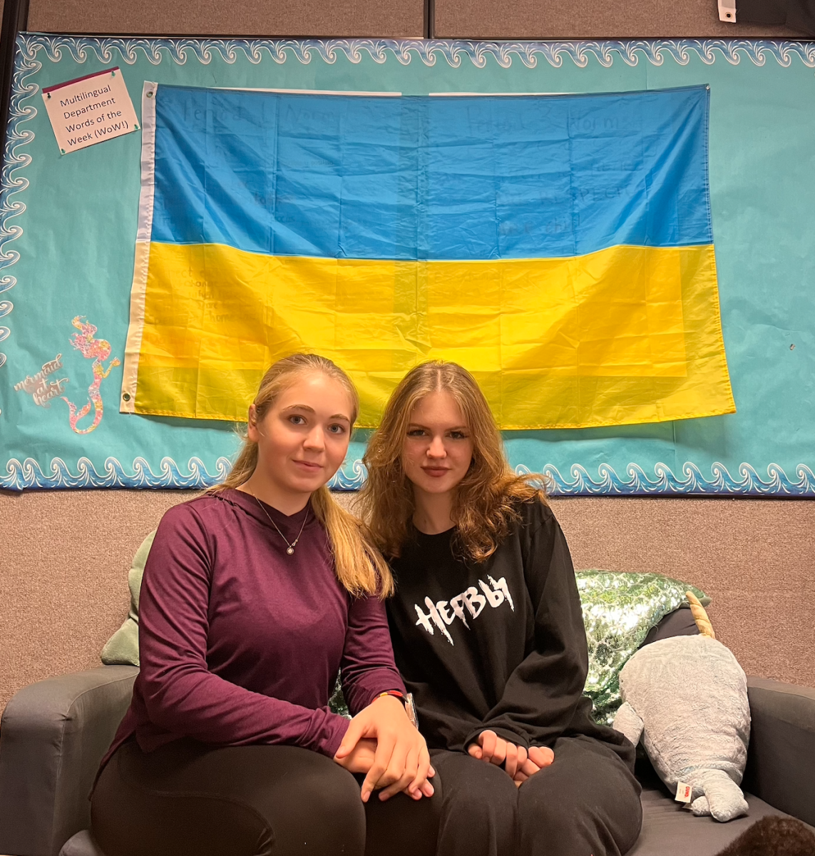 Milana Vasilieva (left) and Nika Zinchenko (right), founders
of the Slavic Club, pose in front of the Ukrainian flag
displayed in Ms. Russell’s classroom which is where they
hold their Slavic Club meetings every Wednesday during
lunch.