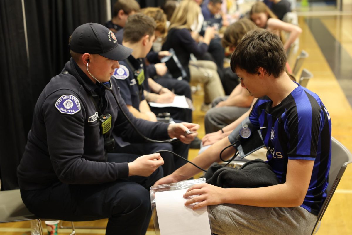 Students getting their hearts checked from the local firemen.