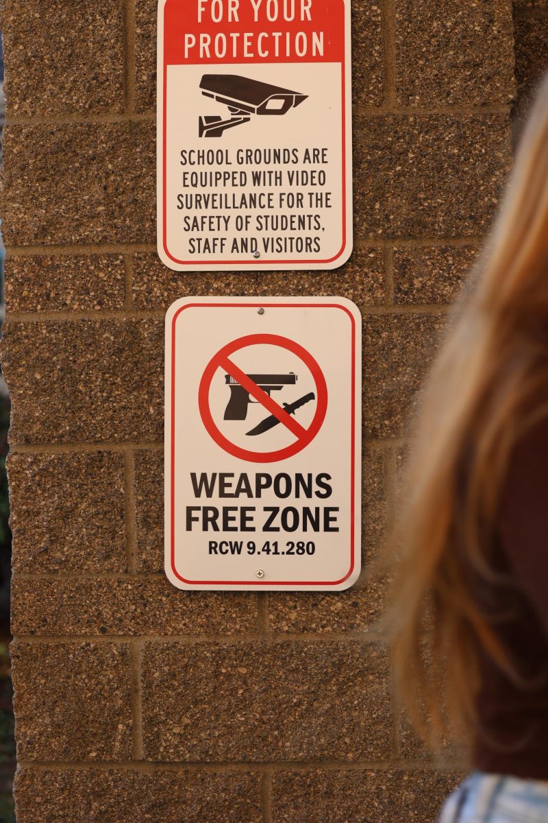 Safety signs that are outside of the main doors of the school building.