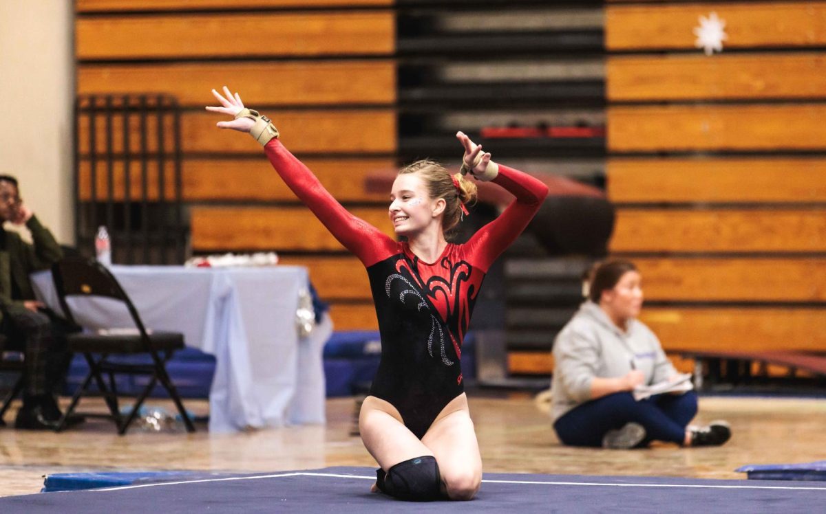 Senior Captain Brooke Adkins finishes a floor routine in December against Holy Names Academy. “We’ve been undefeated for four years in our Metro League [Championships] so we’ve won every meet and we’ve had strong teammates who’ve made it to state finals and big competitions like that.” (Kelly Pecoraro) 