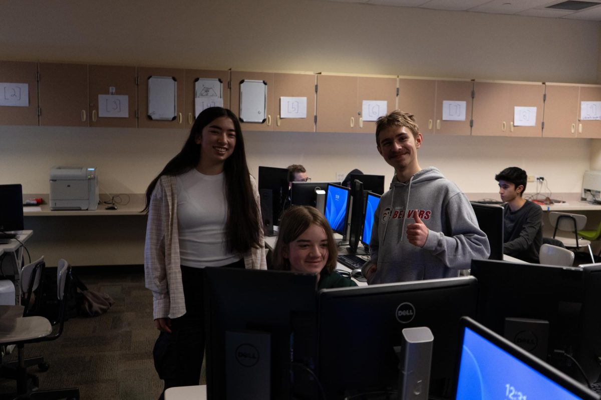 Sophomore Neve Takahashi (left), senior Larry Orlov (right) and freshman Kai Knecht are developing a video game that uses a mix of hand and computer animation.