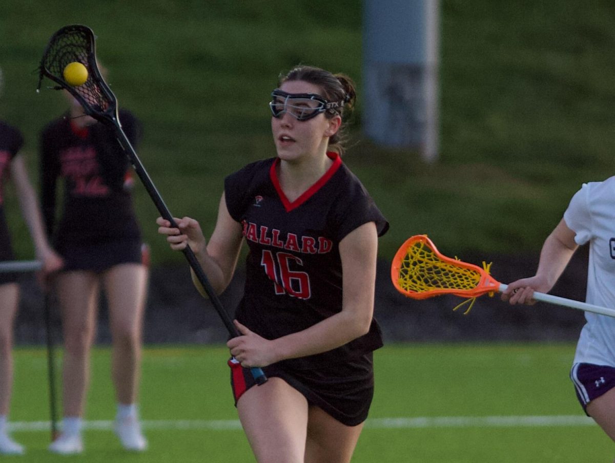 Captain and senior Maddie Singer aims a pass towards her teammates, the energy that she brings to the sport keeping them driven. (Courtesy of Anthony Spinelli)
