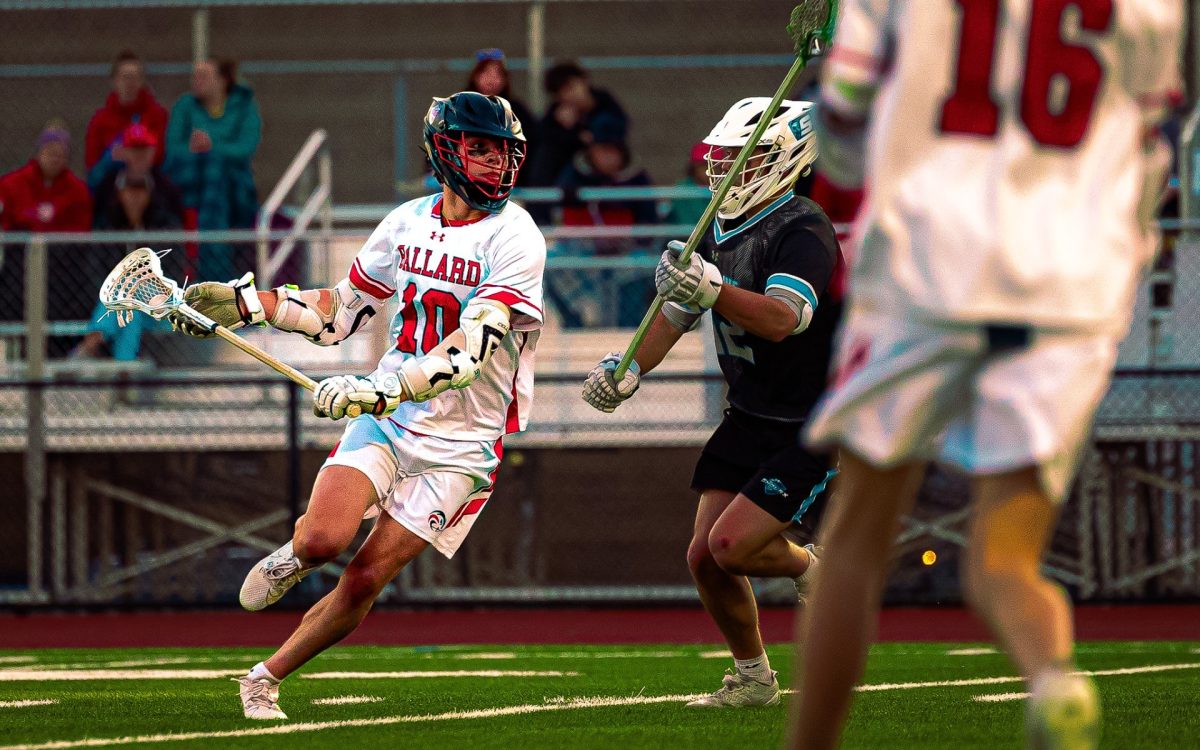 A lacrosse player takes aim to pass to his teammate while the Snohomish opponent tries to block and interfere with the shot, each team fighting to be the first to take home a state title in both school’s histories. 